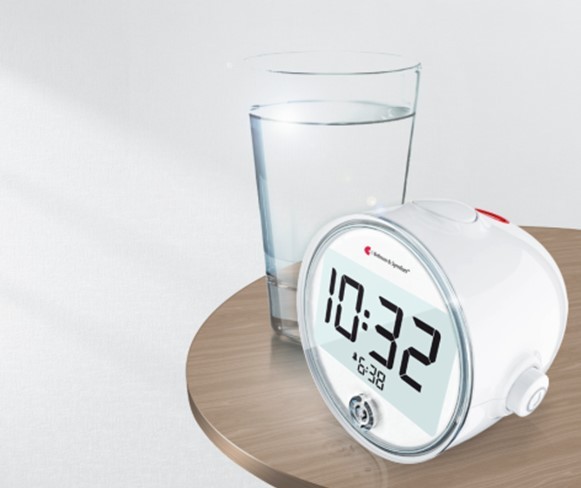 Bellman Classic Alarm Clock on the Table with A Glass oF Water