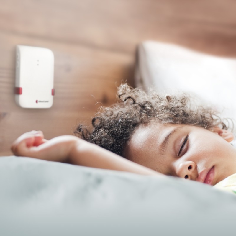 Child Sleeping Soundly with Bellman Baby Monitor Transmitter Watching Over Them