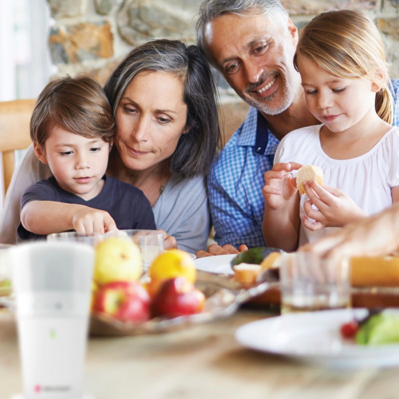 Family Happily Enjoying Lunch Knowing Their Bellman Flash Receiver with Battery Back-Up Will Signal Them If Needed